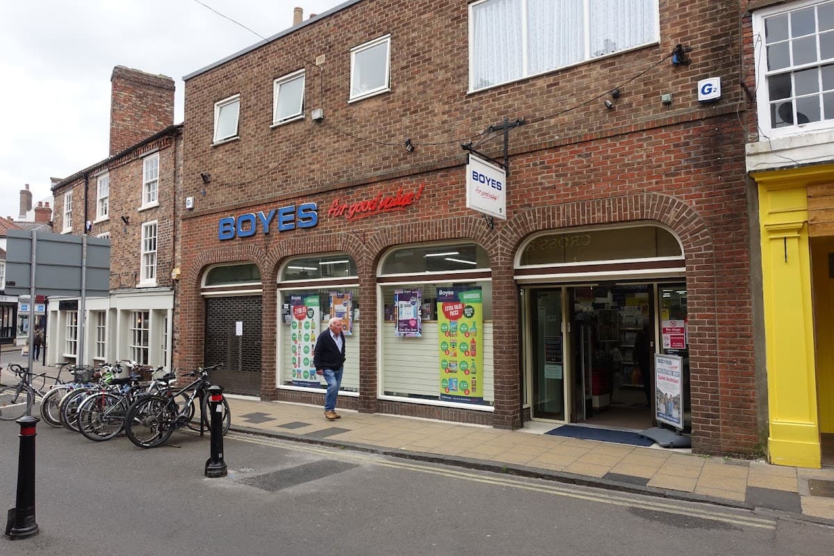 Department store "Boyes" with colorful window displays and bicycles parked outside on a street in York.