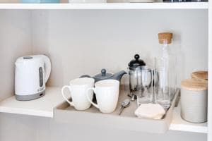 Tea set with cups, kettle, French press, glasses, and jars on a tray in a hotel room at The Dawnay Arms, Yorkshire.