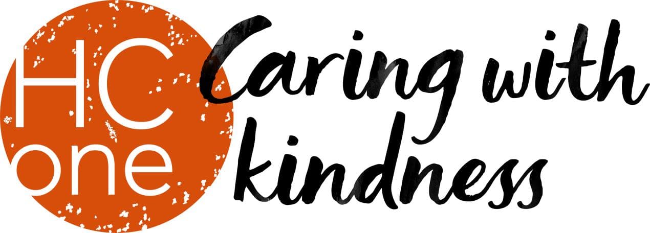 Logo featuring "HC One" in bold white letters with an orange circle, accompanied by the phrase "Caring with kindness" in elegant script.