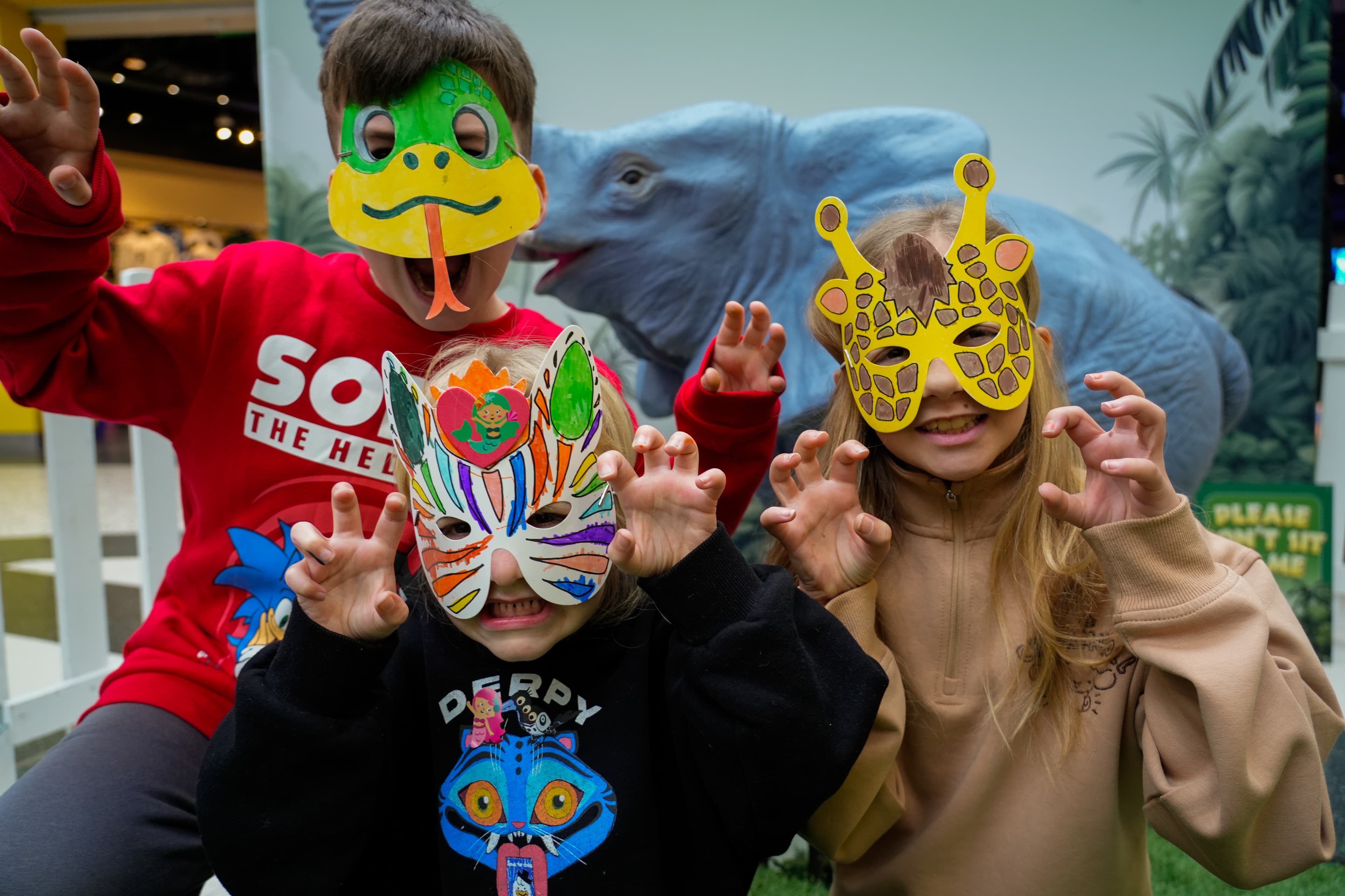 Children wearing colorful animal masks posing playfully