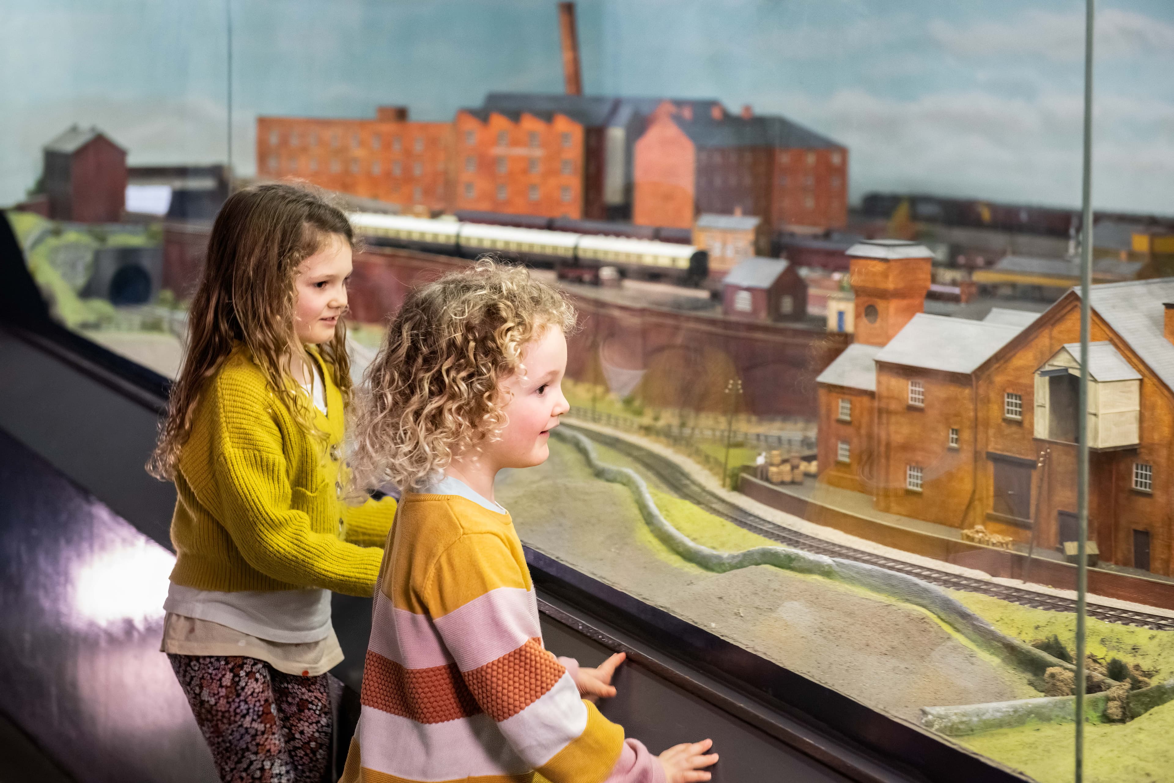 Children observing a detailed model of an industrial Yorkshire town