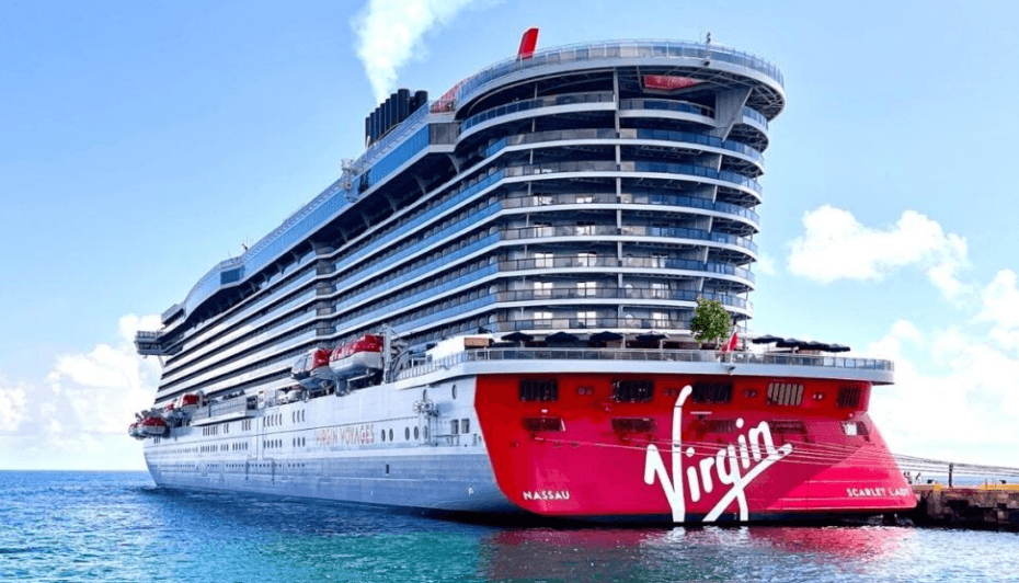 Large modern cruise ship docked at a sunny harbor