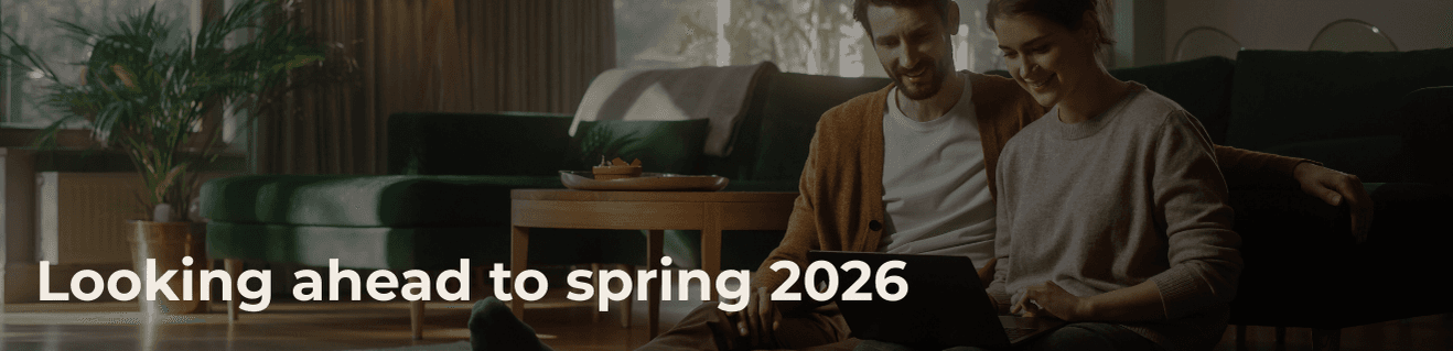 Couple sitting together on floor looking at tablet in cozy living room