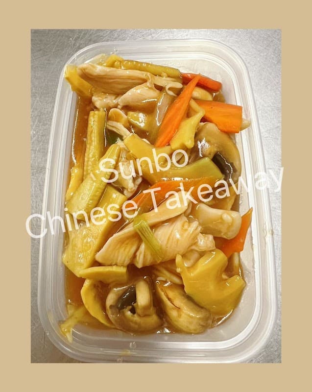 A plastic container filled with chicken and mixed vegetables in a savory sauce.
