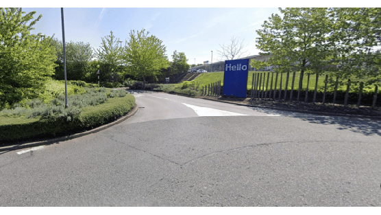Pay & Display parking area with trees and shrubs, featuring a blue "Hello" sign in Balby, Yorkshire.