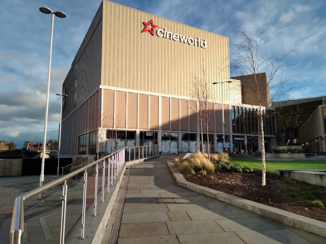 Cineworld building in Barnsley with a modern facade, pathway, and trees under a partly cloudy sky.