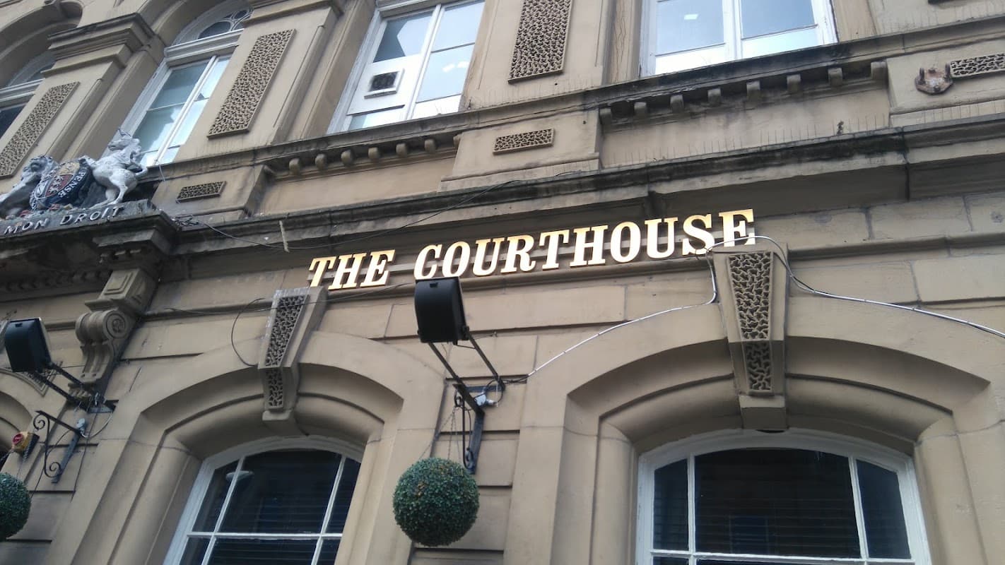 The Courthouse bar sign with ornate stonework and decorative elements on a historic building in Barnsley.