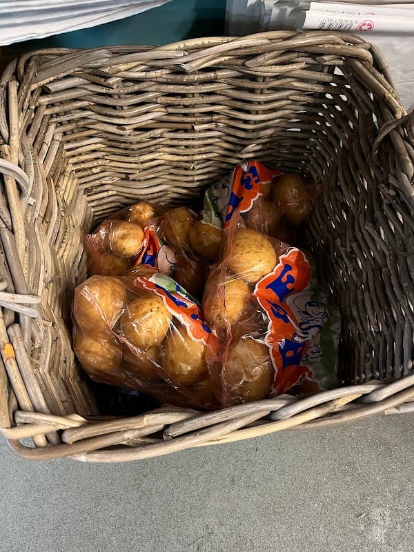 A wicker basket containing several bags of oranges at Bempton Post Office.