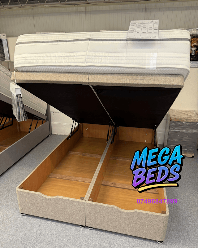 A stylish bed frame with a lifted mattress revealing storage space underneath, showcased in a shop setting.