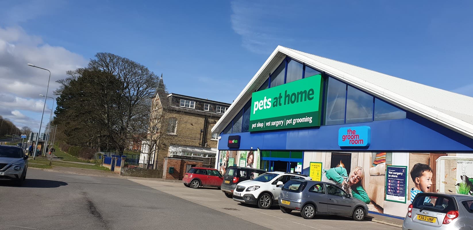 Exterior of Pets at Home shop in Bridlington, featuring a modern design, parking area, and grooming services sign.