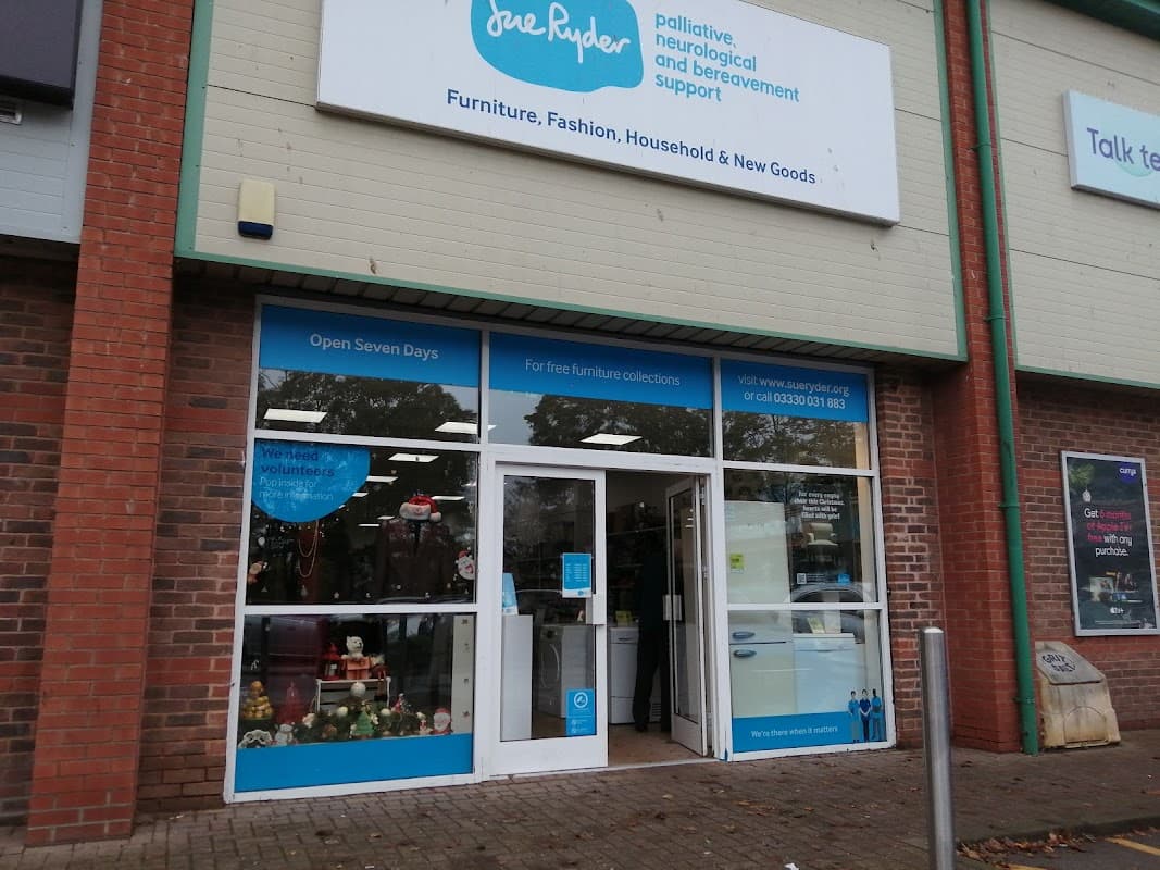 Sue Ryder storefront with a blue sign, showcasing furniture and household goods, and a welcoming entrance.