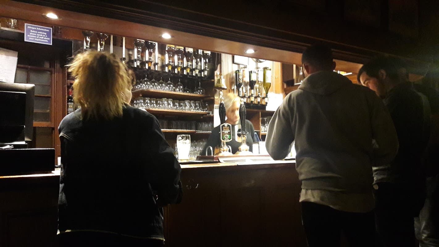 Spencer St Car Park sign, with parking spaces and a Pay & Display machine, surrounded by trees in Beverley, Yorkshire.