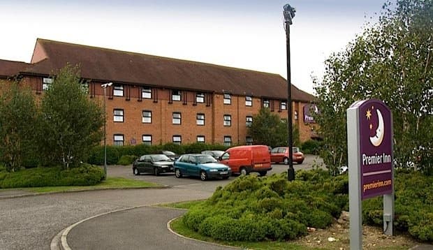 Premier Inn York South West hotel exterior with brick building, cars parked, and green landscaping.