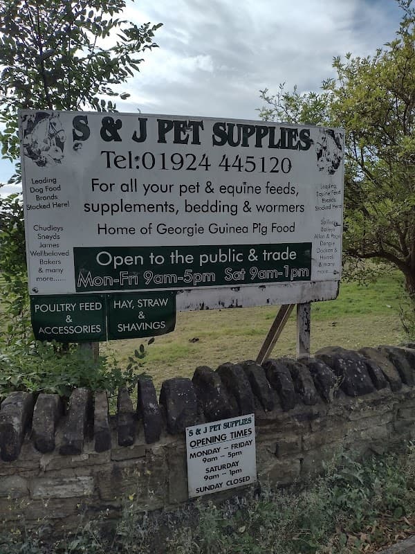 Sign for S & J Pet Supplies in Birstall, Yorkshire, listing services, contact info, and opening hours.