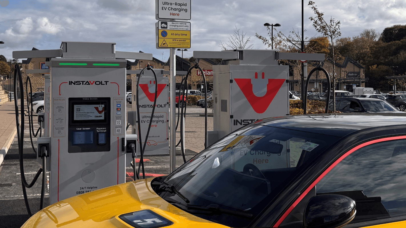 InstaVolt charging station with two EV chargers and a yellow car parked nearby in Bolsterstone, Yorkshire.
