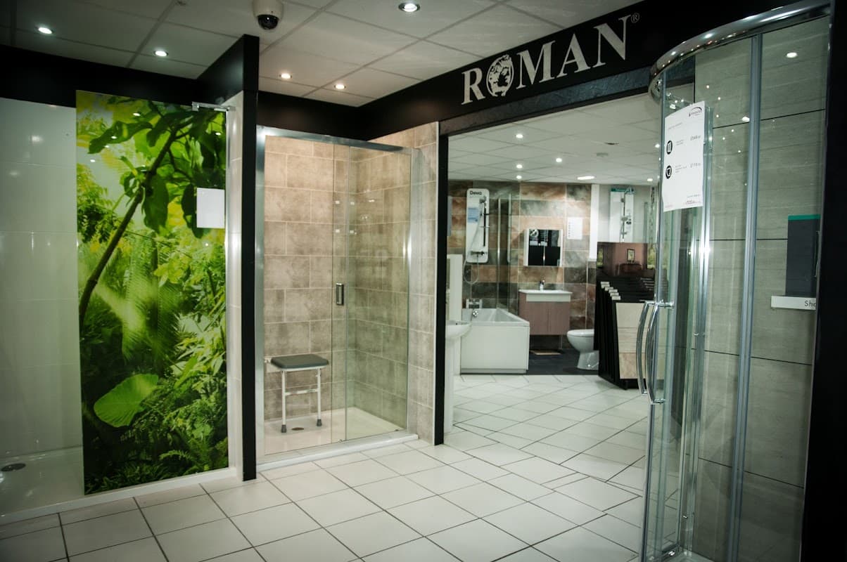 Modern bathroom display featuring a glass shower, tiled walls, and greenery mural at Windsor Bathrooms in Bradford.