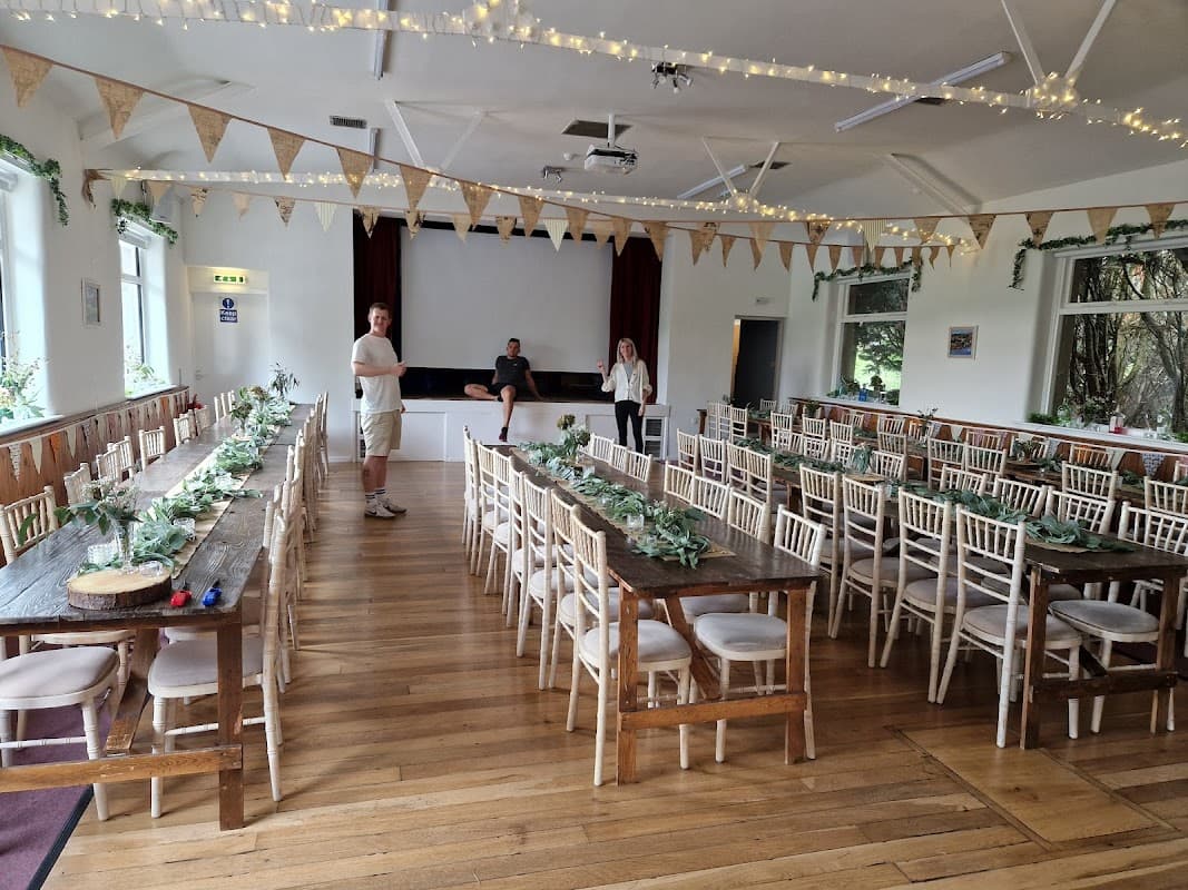 Spacious event venue with wooden tables, chairs, bunting, and fairy lights, set up for a gathering in Bradley, North Yorkshire.