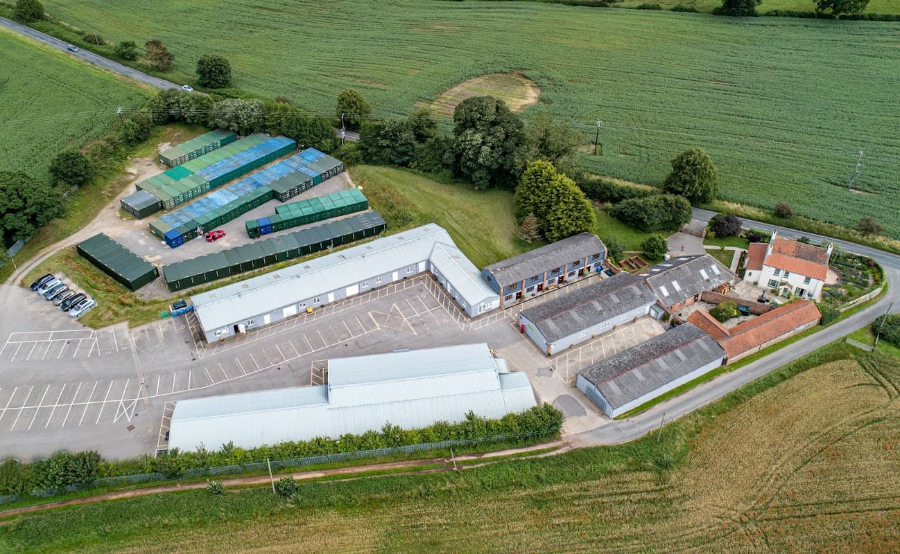 Aerial view of Sycamore Business Park featuring buildings, parking, and surrounding green fields in Bridge Hewick, Yorkshire.