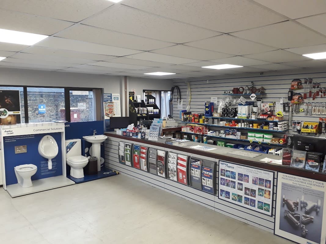 Interior of Crossling Brighouse showing shelves stocked with tools, plumbing supplies, and a display of toilets.
