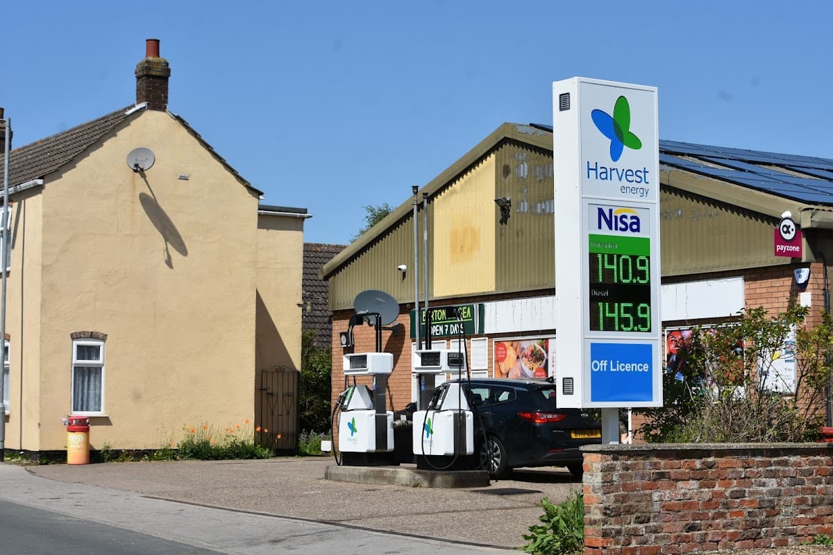 Grocers with a fuel station, signage for Harvest Energy and Nisa, and a residential building nearby in Burton Pidsea.
