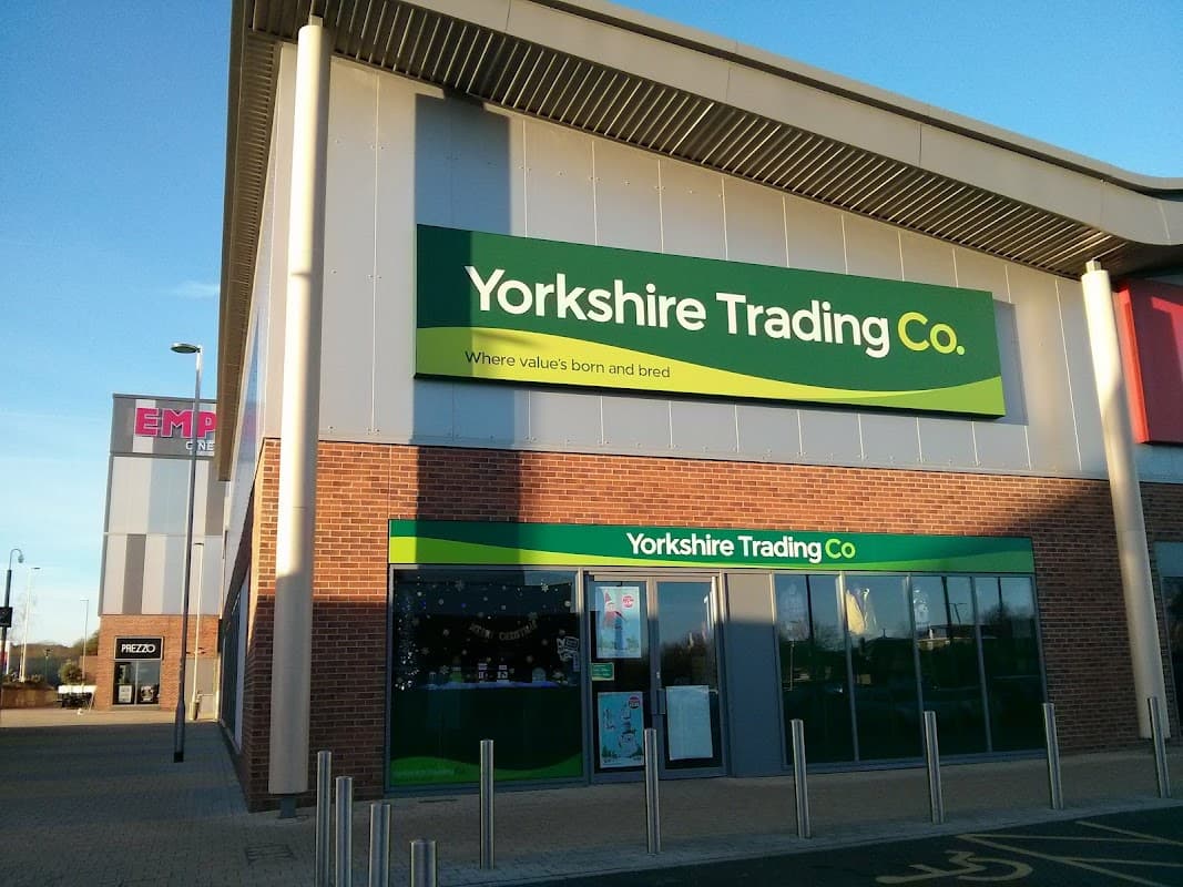 Yorkshire Trading Co. storefront with green signage, brick facade, and clear blue sky in Catterick Garrison.