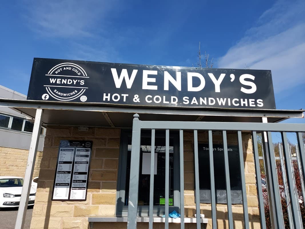 Sign for Wendy's Sandwich Shop featuring "Hot & Cold Sandwiches" in Clayton West, Yorkshire, with a gated entrance.