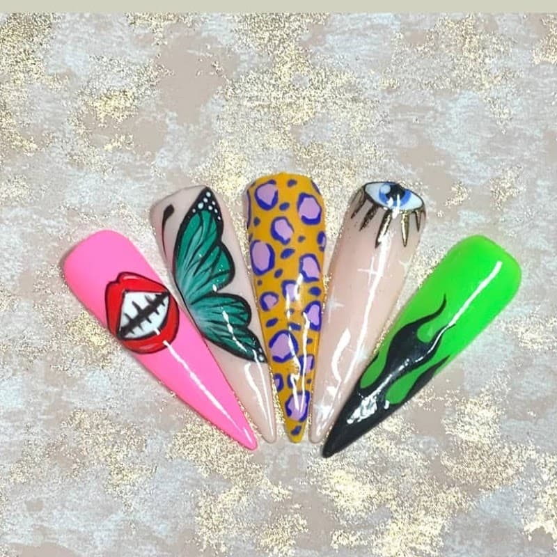 Colorful nail art showcasing designs like lips, a butterfly, leopard print, an eye, and abstract patterns on long nails.