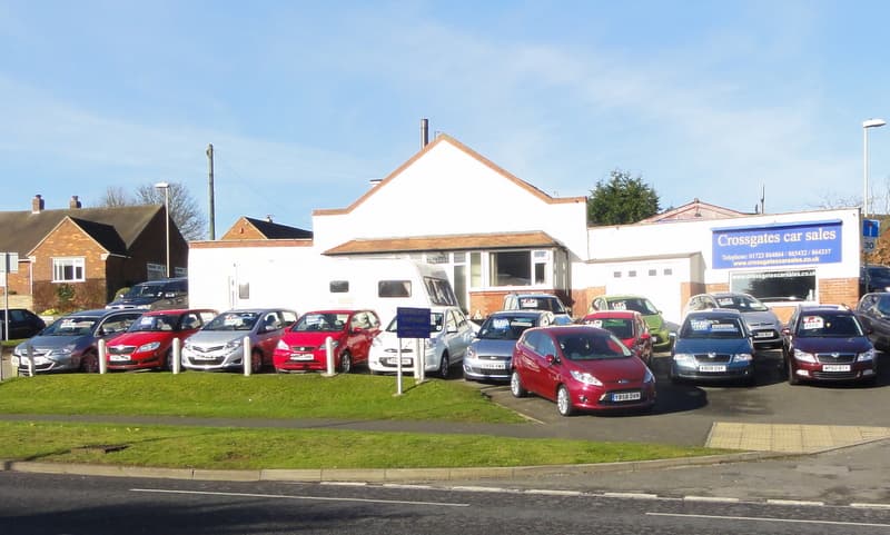 Hopes Garage at Crossgates car sales, featuring a variety of parked cars and a shop front in Scarborough, Yorkshire.