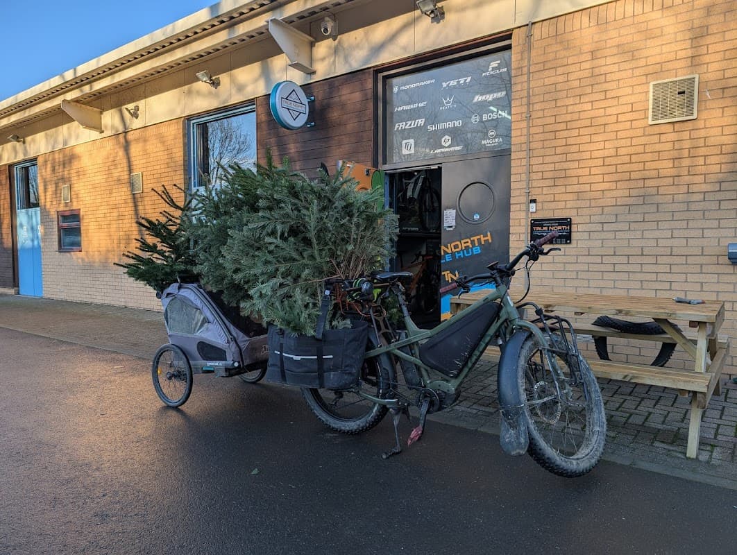 A bicycle with a trailer loaded with Christmas trees outside the Step Business Centre in Deepcar, Yorkshire.