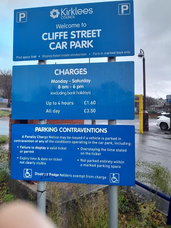 Welcome sign for Cliffe Street Car Park with parking charges and rules displayed, located in Dewsbury, Yorkshire.