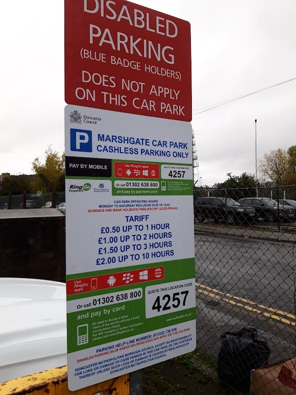 Sign for Marshgate Car Park in Doncaster detailing parking tariffs and disabled parking information.