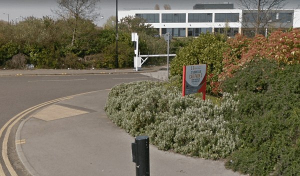 Pay & Display sign for YourParkingSpace, surrounded by greenery and a modern building in Doncaster, Yorkshire.