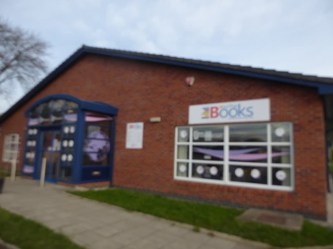 Brick building with large windows, blue trim, and a sign reading "More Than Books" in Eastfield, North Yorkshire.