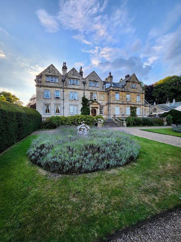 Victorian-style hotel with manicured gardens and lavender, set against a blue sky in Egton Bridge, Yorkshire.