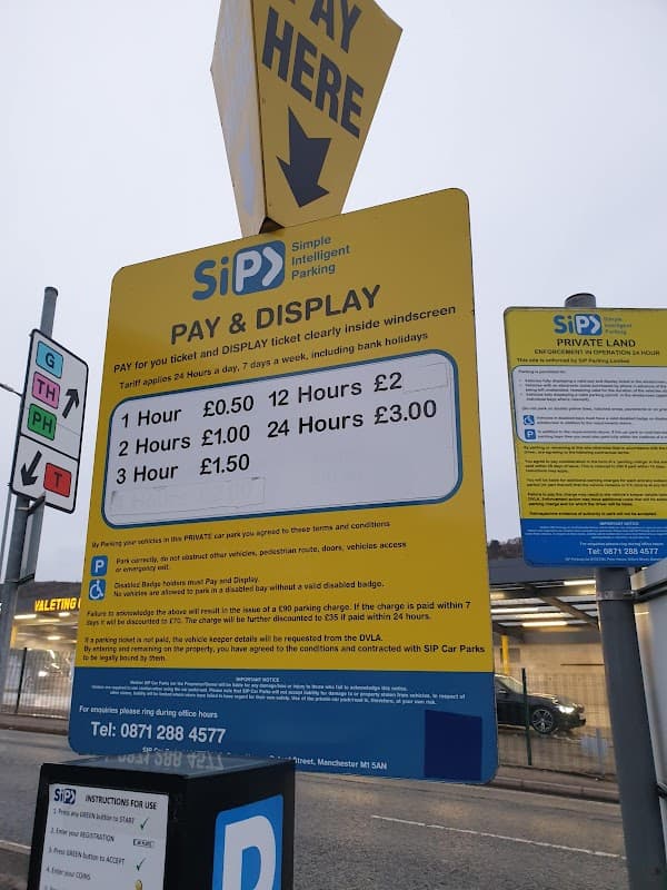 Pay & Display sign with parking rates and instructions at SiP Car Park in Exley, Yorkshire.