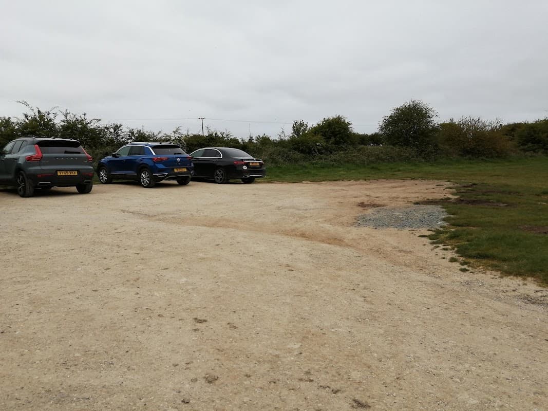 Pay & Display parking area with several parked cars and grassy surroundings in Flamborough, Yorkshire.