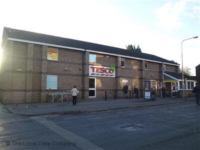 Brick building with a Tesco sign, people outside, and a clear sky in Great Driffield, Yorkshire.
