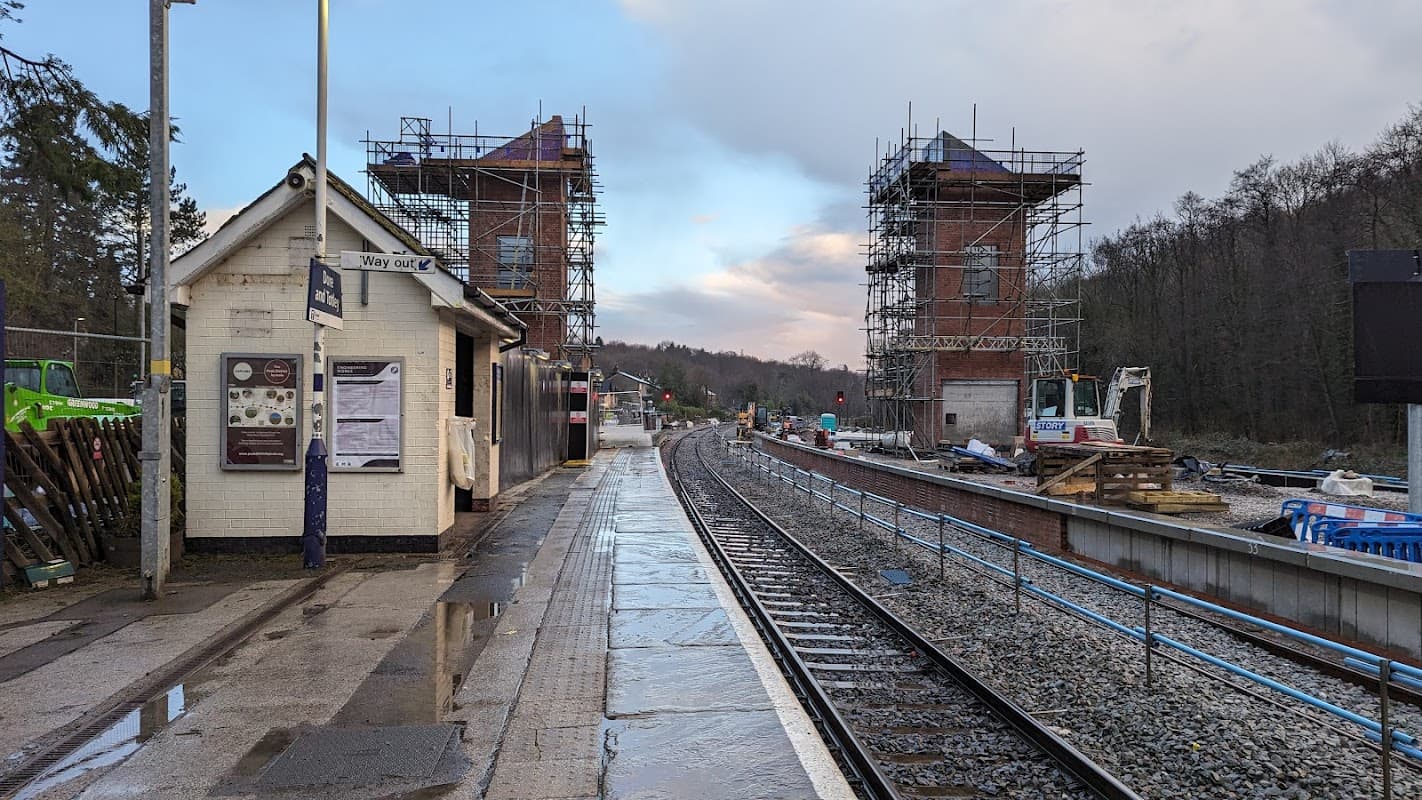 Park and Ride station with construction scaffolding, tracks, and a small building beside a wet platform in Greenhill, Yorkshire.