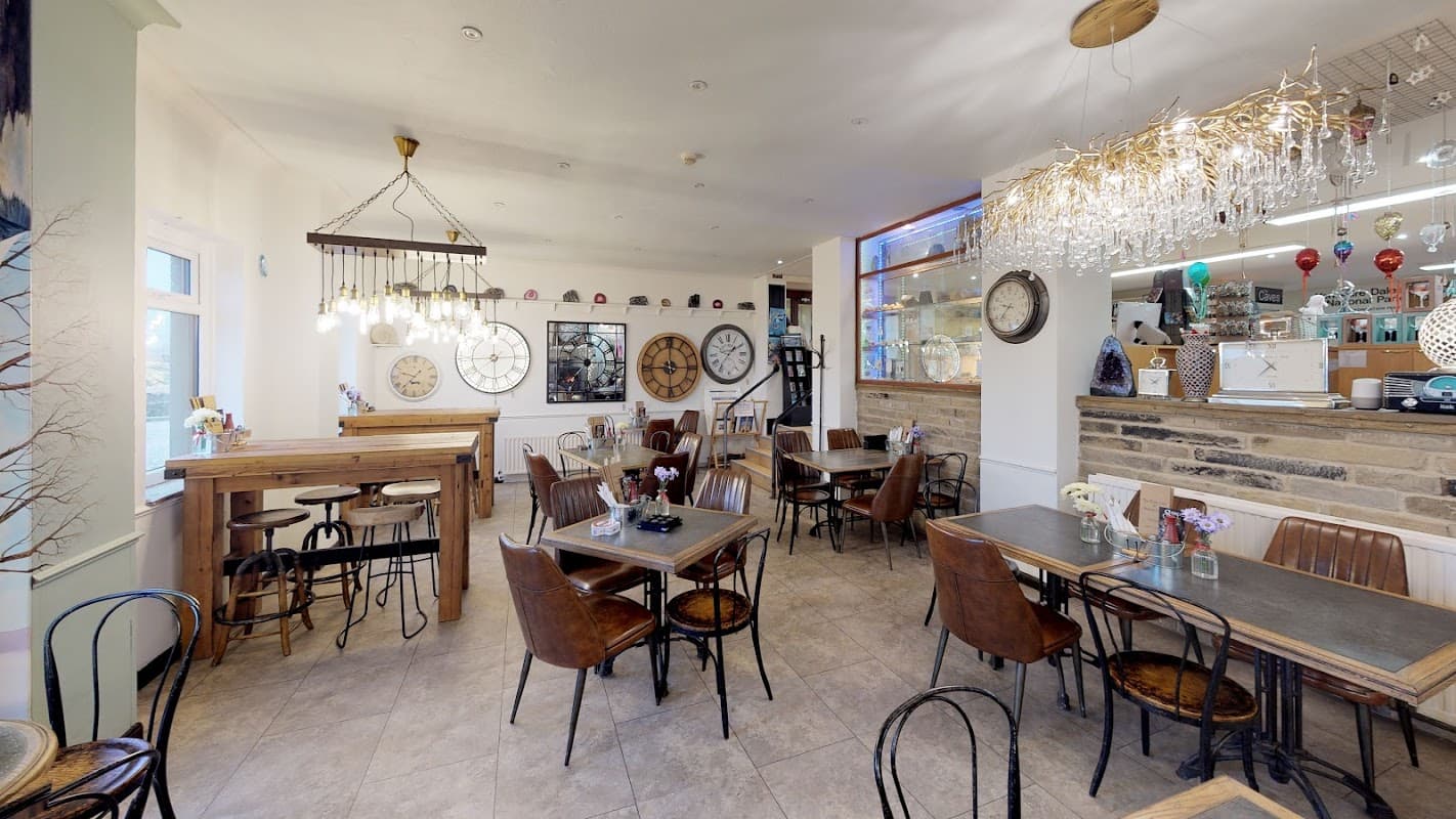 Cozy cafe interior with wooden tables, vintage decor, and chandeliers, featuring a warm and inviting atmosphere.