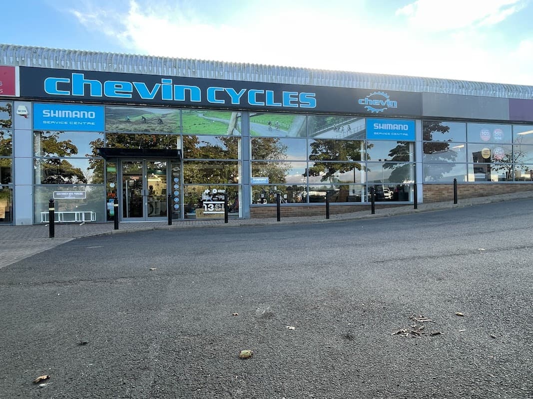 Chevin Cycles storefront in Harrogate, featuring large windows, signage, and a service center entrance.