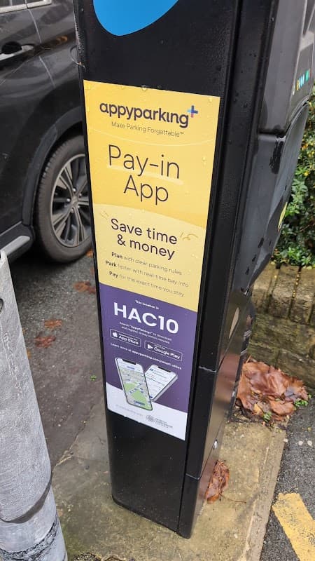 Connected Kerb Charging Station with signage for app-based parking payment and instructions in Harrogate, Yorkshire.