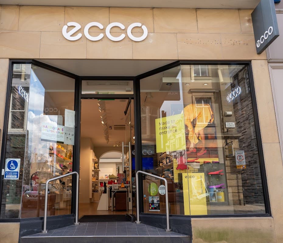 ECCO shoe shop entrance with large glass doors, displaying colorful footwear and signage in Harrogate, Yorkshire.