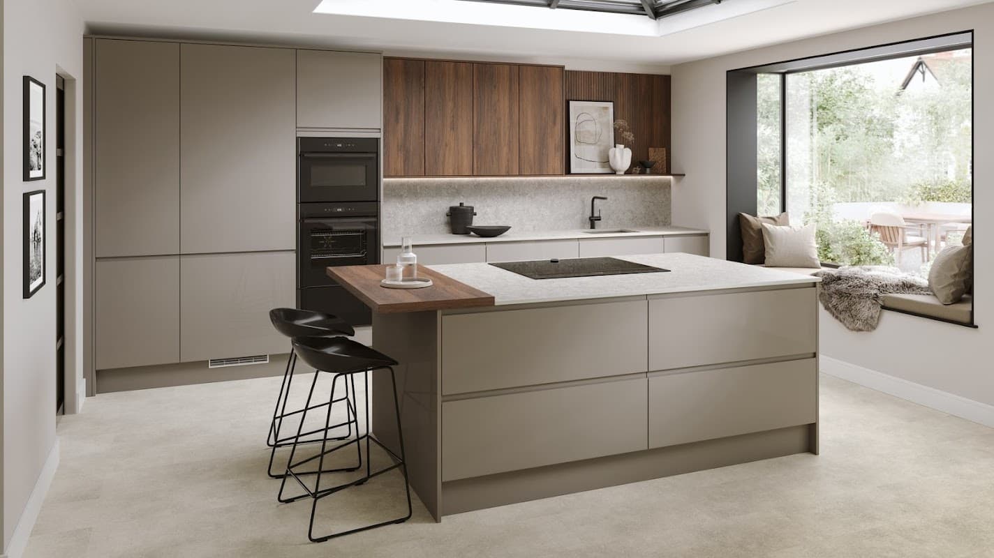 Modern kitchen featuring sleek cabinetry, a central island with seating, and large windows overlooking a garden.