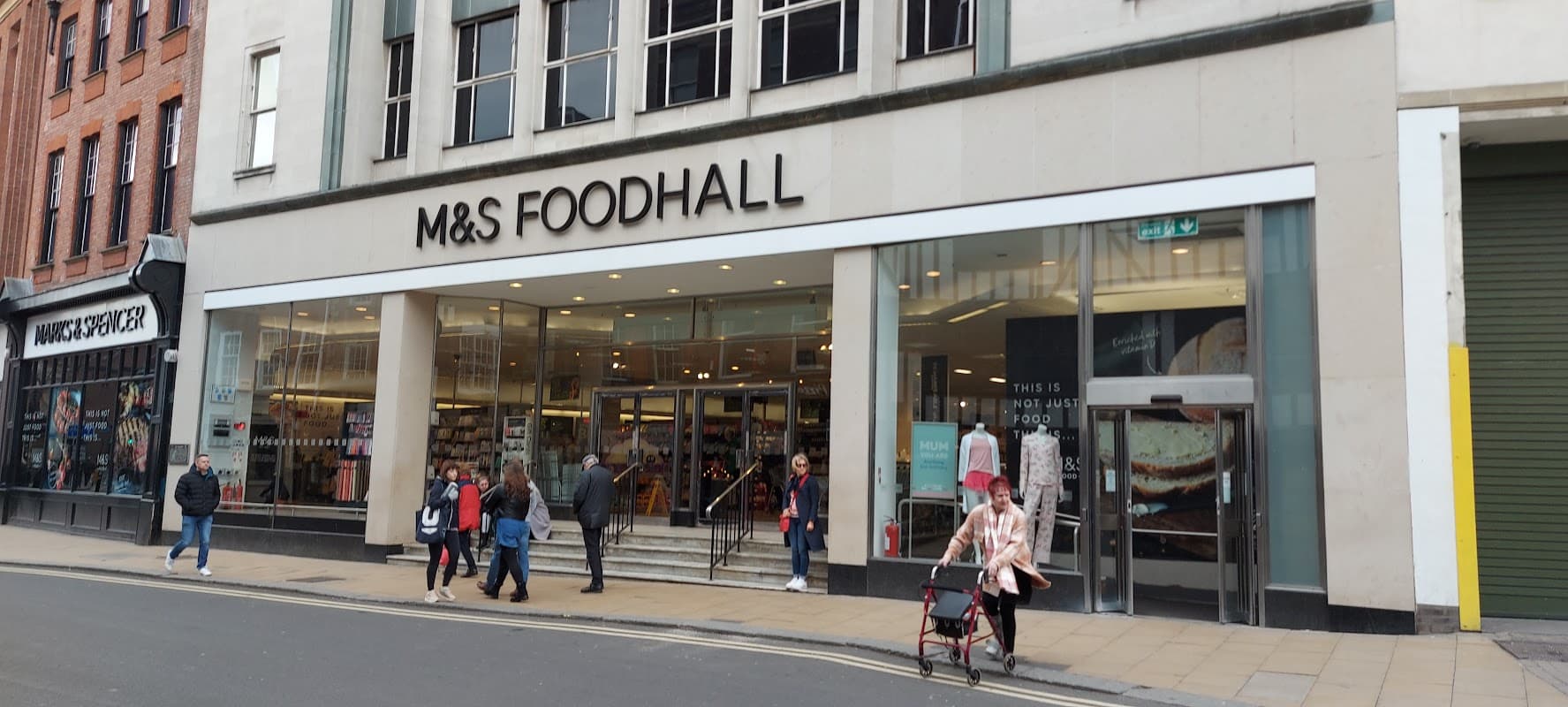 Marks & Spencer Foodhall storefront with shoppers, featuring large glass doors and prominent signage in Harrogate.