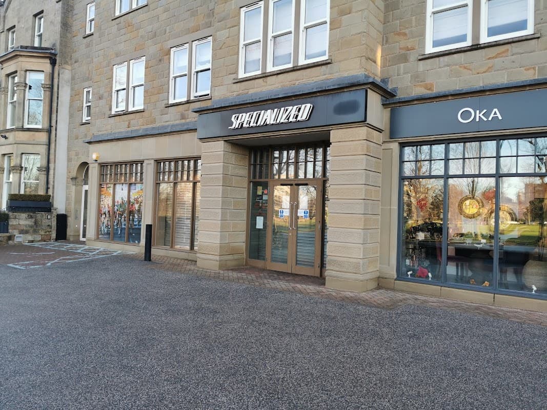 Specialized Concept Store in Harrogate features a stone facade, large windows, and a neighboring shop, Oka.