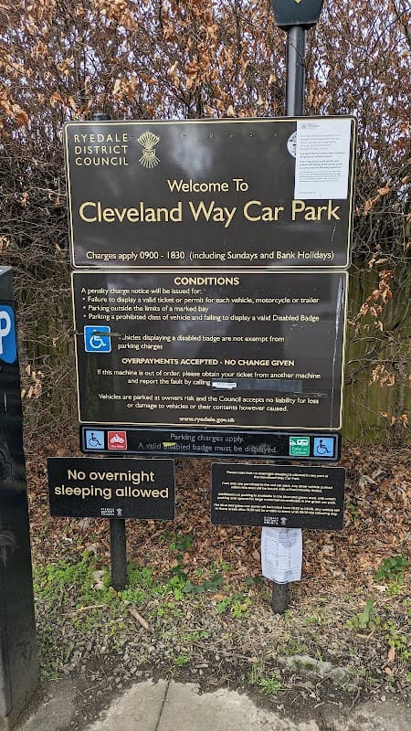 Signage for Cleveland Way Car Park in Helmsley, Yorkshire, detailing parking conditions and payment instructions.