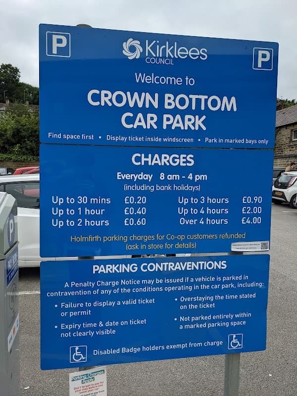 Sign for Crown Bottom Car Park with parking charges, hours, and regulations in Holme Valley, Yorkshire.