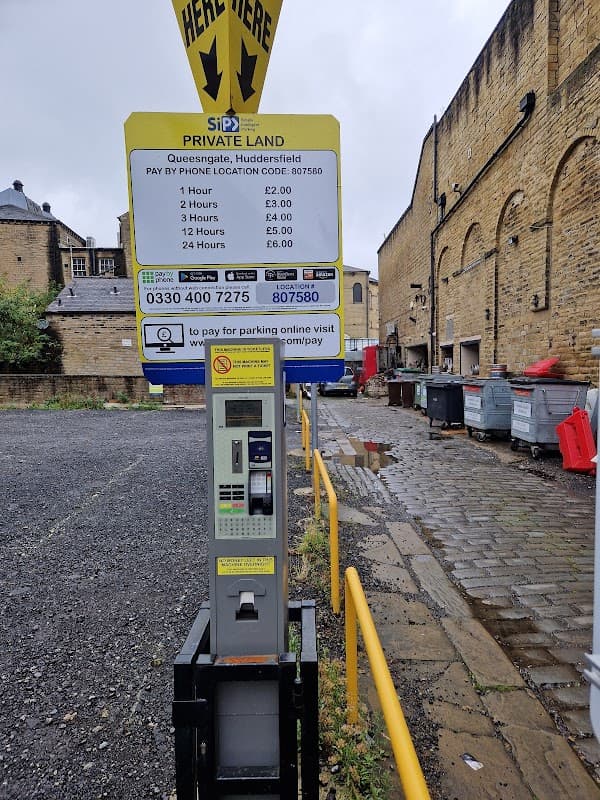 Pay & Display parking machine at Back Queen St Car Park, Huddersfield, with pricing details and contact information.