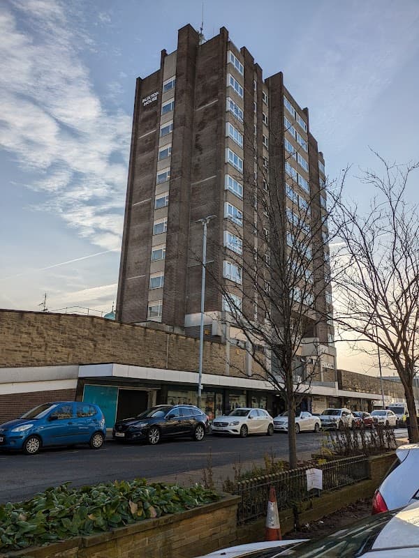 Civic Centre Car Park with a multi-story building, parked cars, and trees in Huddersfield, Yorkshire.