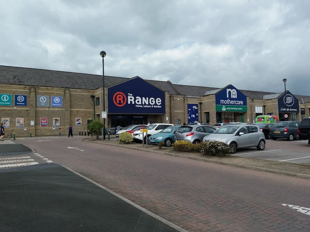 Great Northern Retail Park features shops including The Range and Mothercare, with a parking area and cloudy sky.